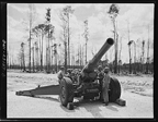 Men of the 51st Defense Battalion also trained with large field pieces. In this photo they operate a 155 millimeter howitzer, March 1943.