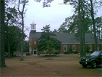 Building 17, Catholic Chapel with original historic cupola. Camp Lejeune’s Roman Catholic Chapel was first dedicated as St. Aloysius on December 6, 1942, in memory of Father Aloysius Schmitt, the first base chaplain and first Catholic chaplain to die in World War II. It was rededicated at St. Francis Xavier Chapel on January 27, 1943. Each of the ten stained glass windows was designed by New Jersey artist Katherine Lamb Tait and depicts two life-size images of saints of Catholic tradition. 